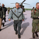 Rumsfeld strides across the Andrews Air Force Base tarmac, toward his intended vagina.